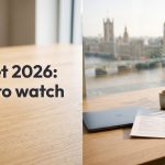A co-working desk with a report and a mug, overlooking Westminster through a large window.